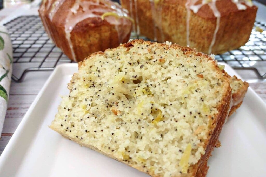 closeup of a slice of glazed lemon poppy seed bread made in the air fryer