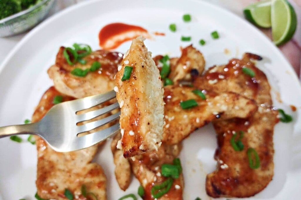honey sriracha air fryer chicken on a fork