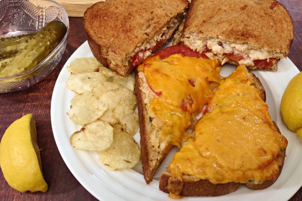 open face air fryer tuna melt on a plate with chips and a half sandwich on top
