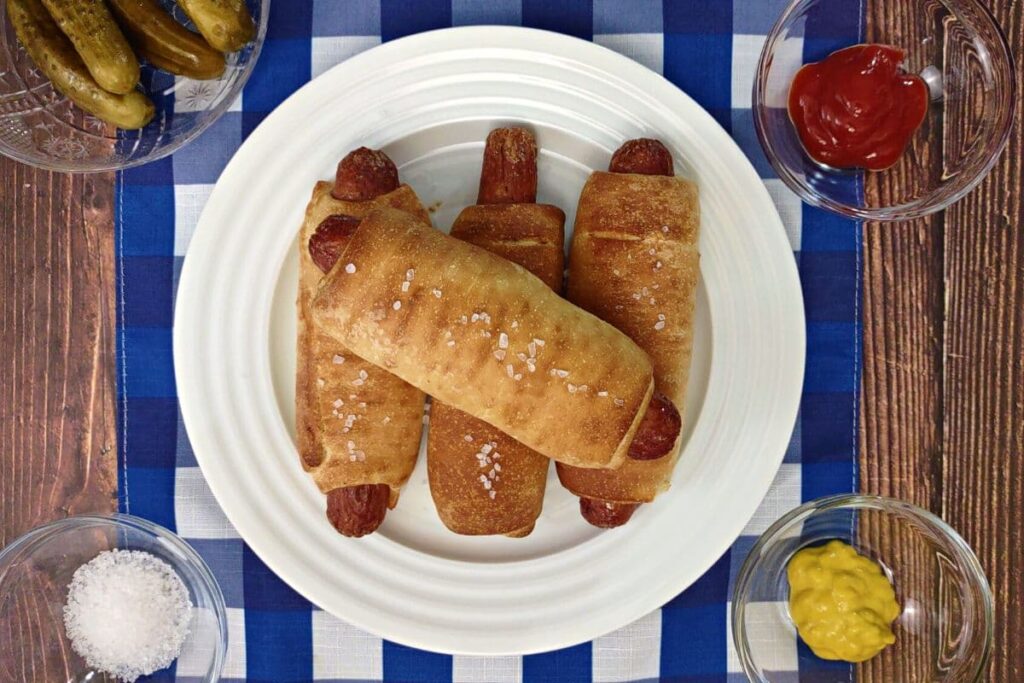 overhead view of nathan's air fryer pretzel dogs on a plate
