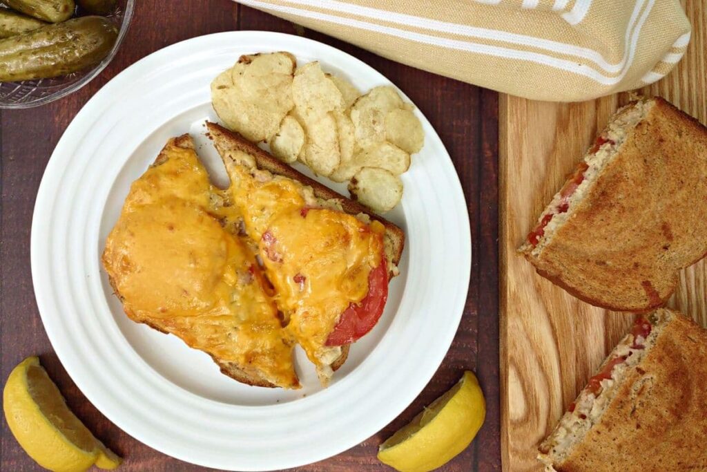 overhead view of open face air fryer tuna melt on a plate with chips