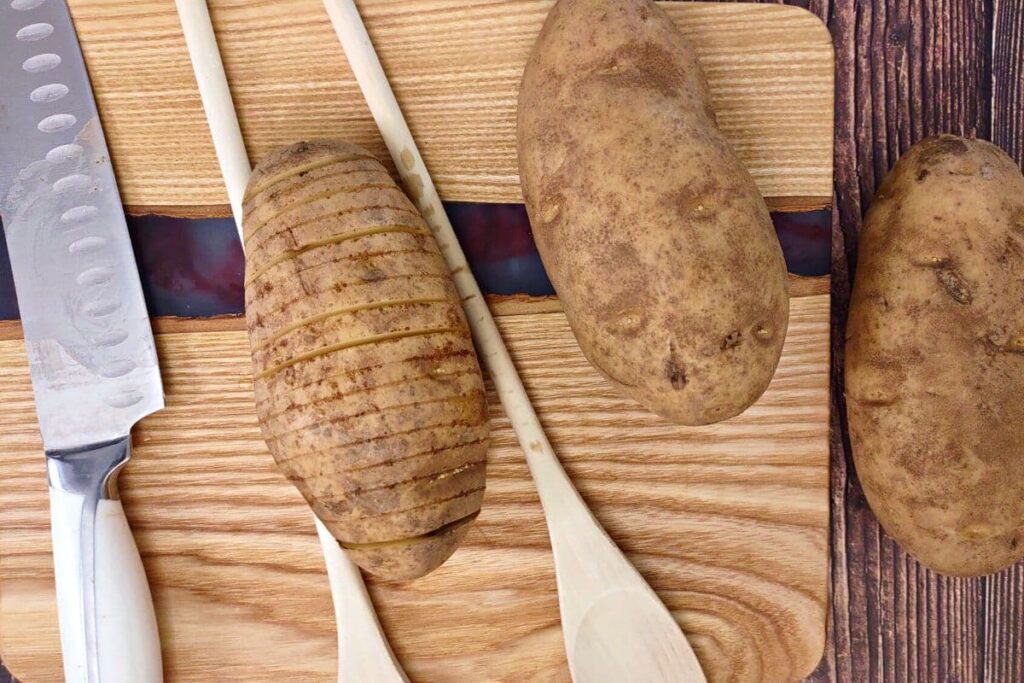 place spoons around potato to help easily cut slices