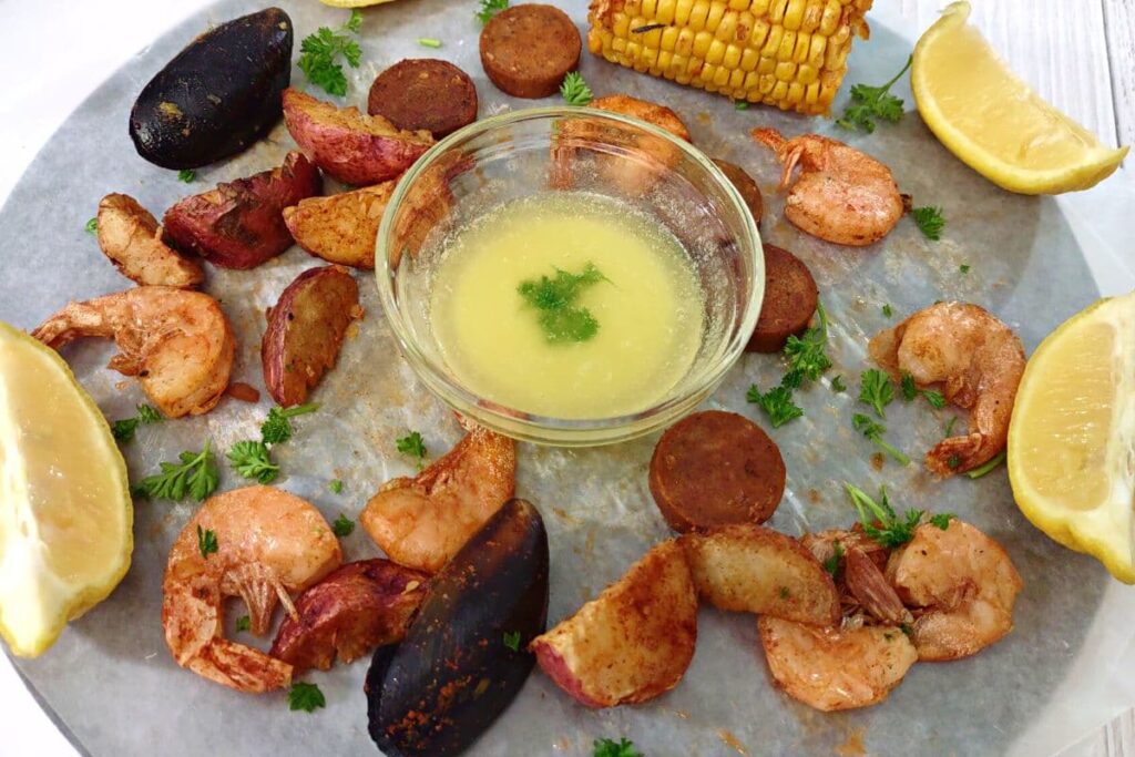 reheated seafood boil from the microwave spread out around melted butter