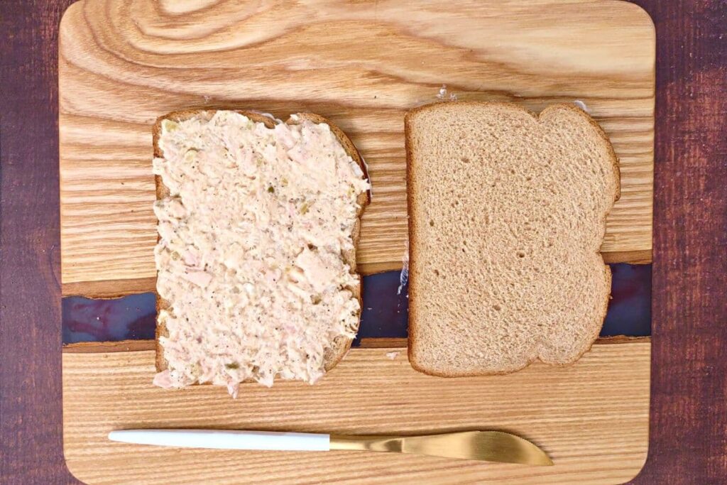 spread tuna over a slice of bread