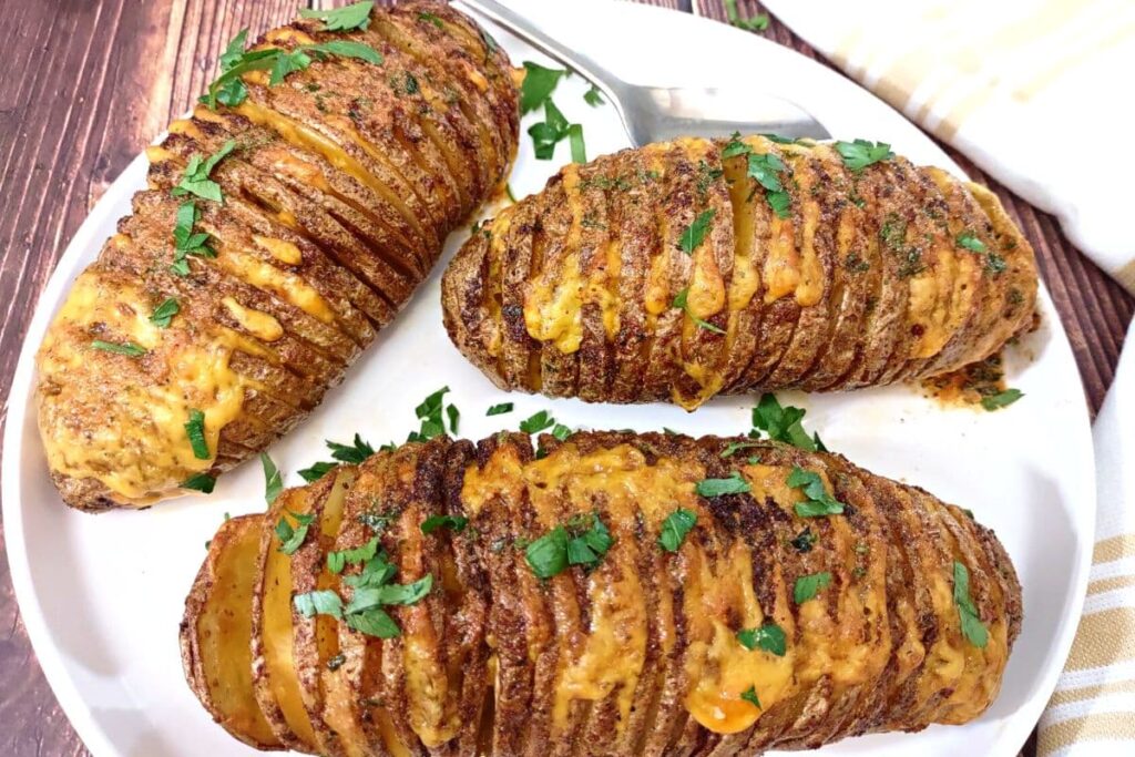 three air fried hasselback potatoes with cheese oozing out
