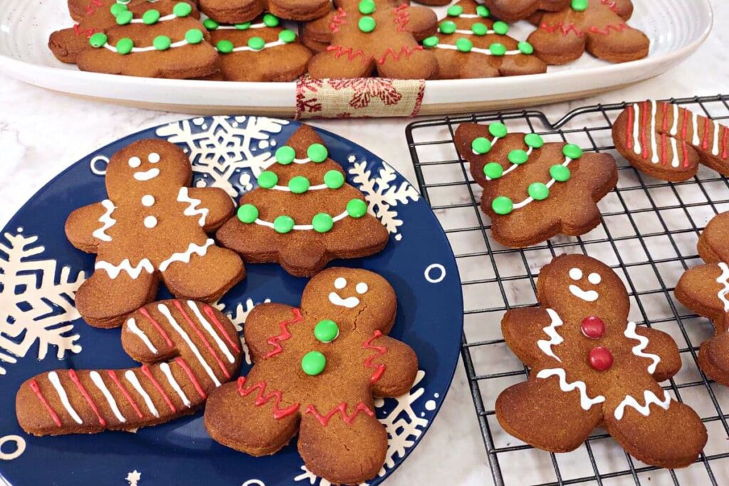 various gingerbread cookies on winter themed plates and platters