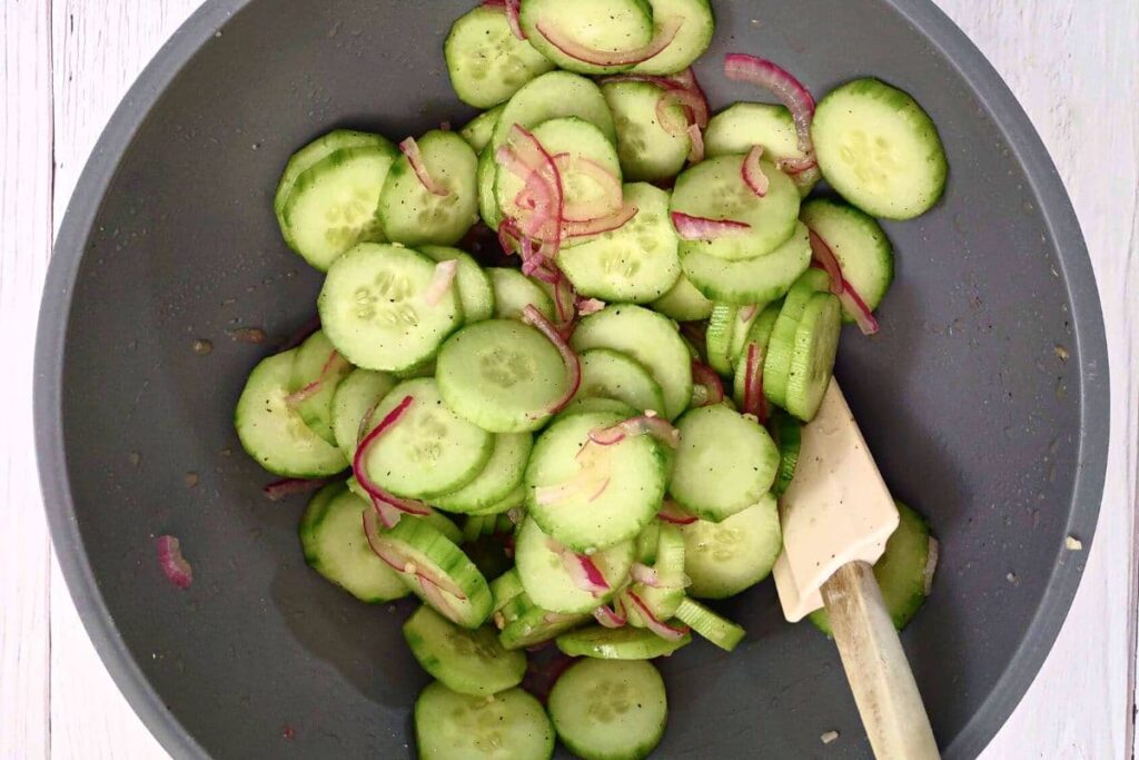 add cucumber slices to onion mixture and stir