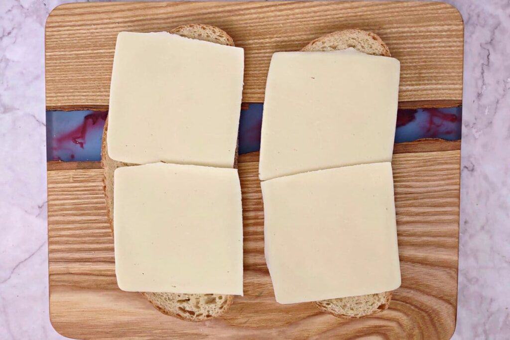 add slices of mozzarella cheese to the bread