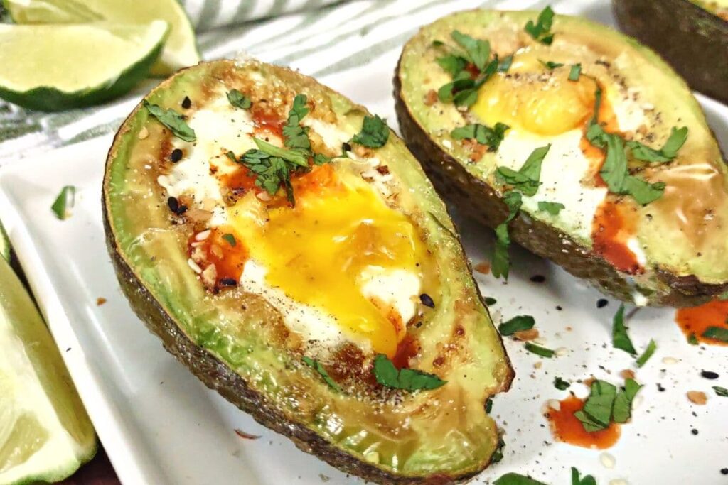 air fryer avocado egg with a cracked yolk on a plate