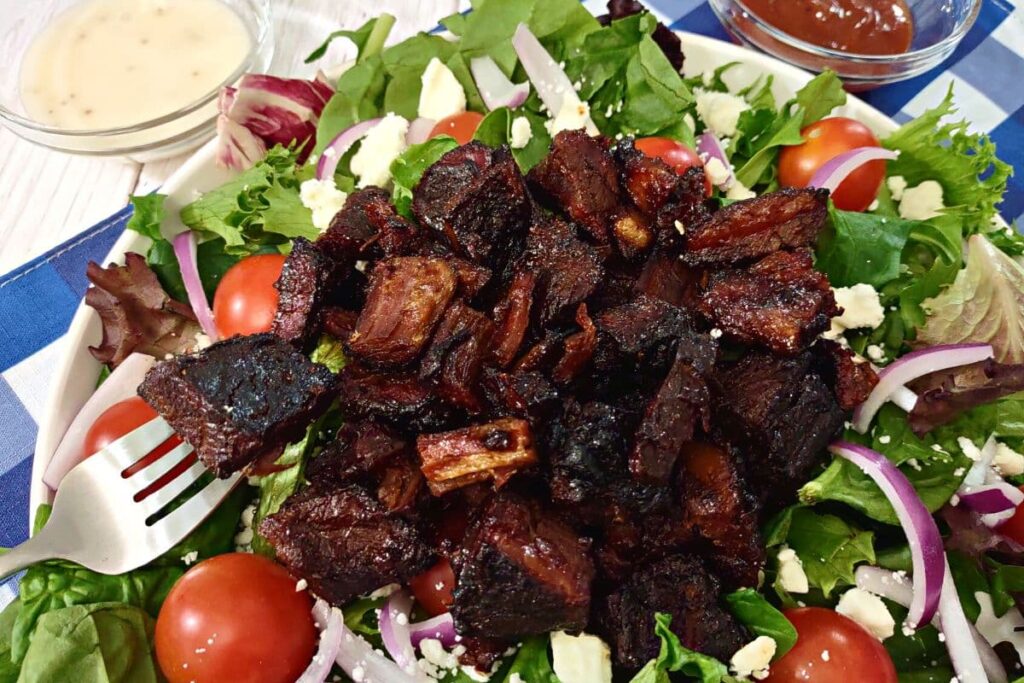 air fryer burnt ends salad with a fork