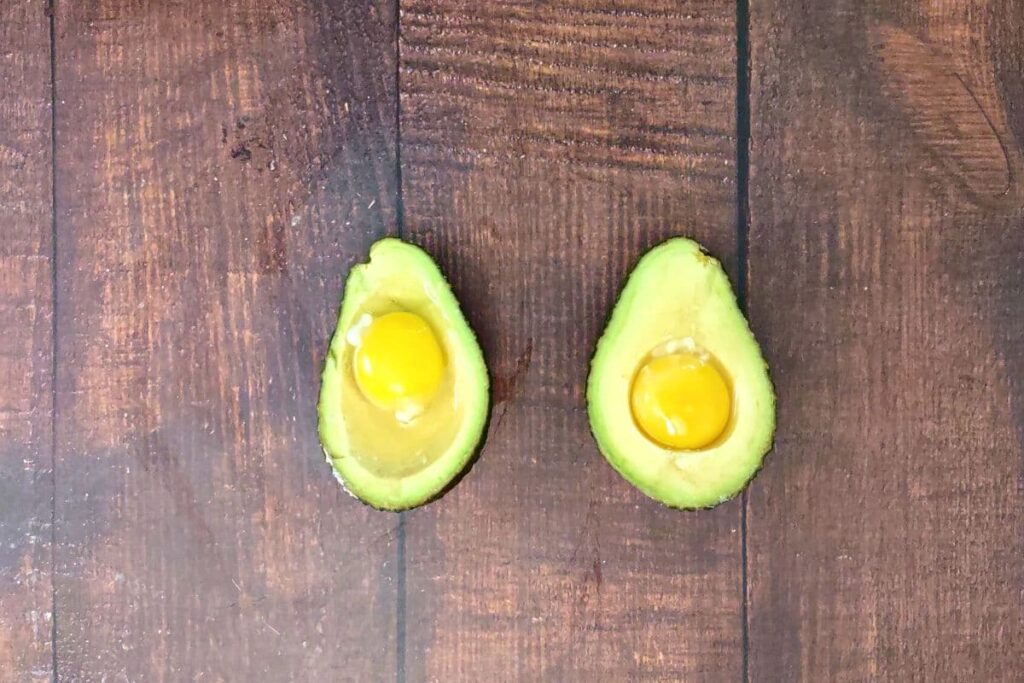 crack eggs into the avocado where the pit was