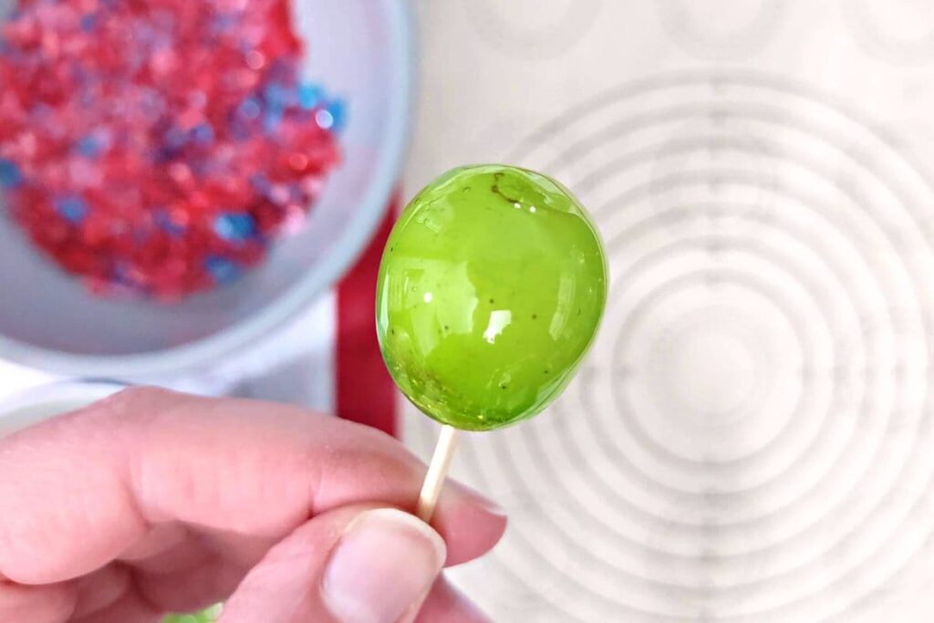 dip your grape into the melted candy to coat