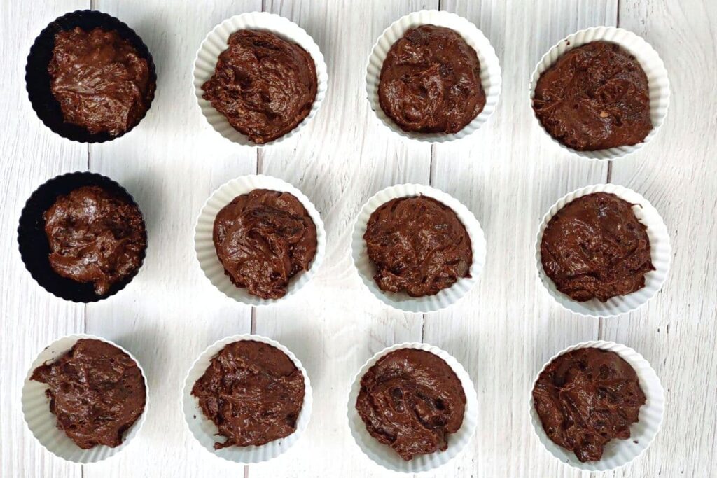 fill muffin cups with chocolate batter