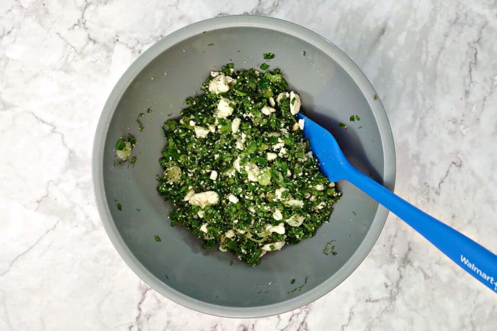 in a small bowl combine spinach, onions, feta, and seasonings