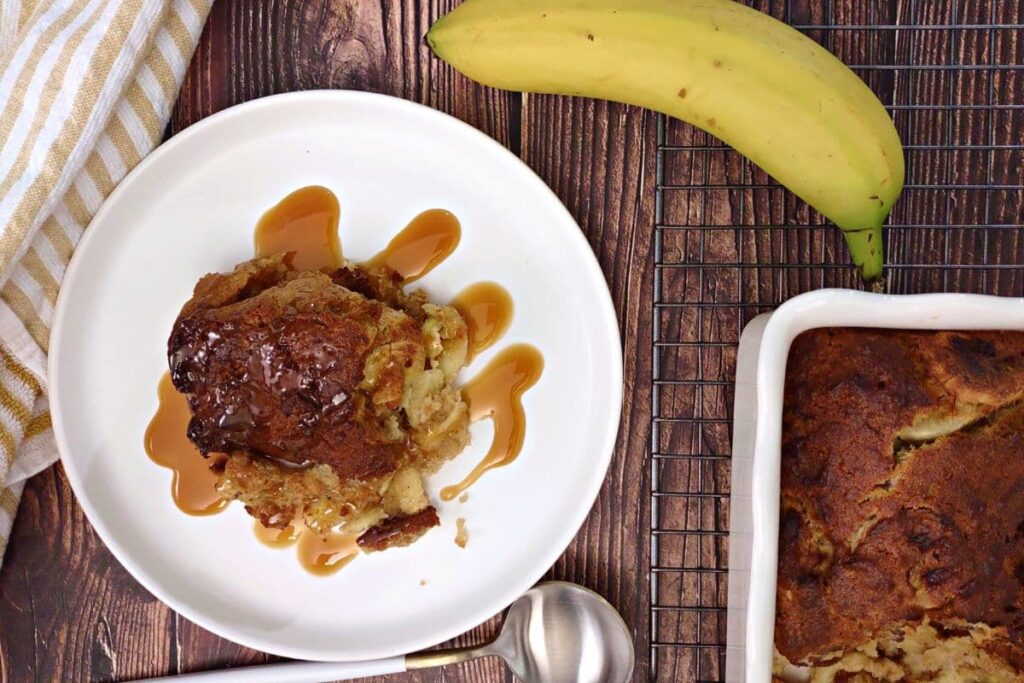 overhead view of air fryer banana bread pudding on a plate with caramel sauce