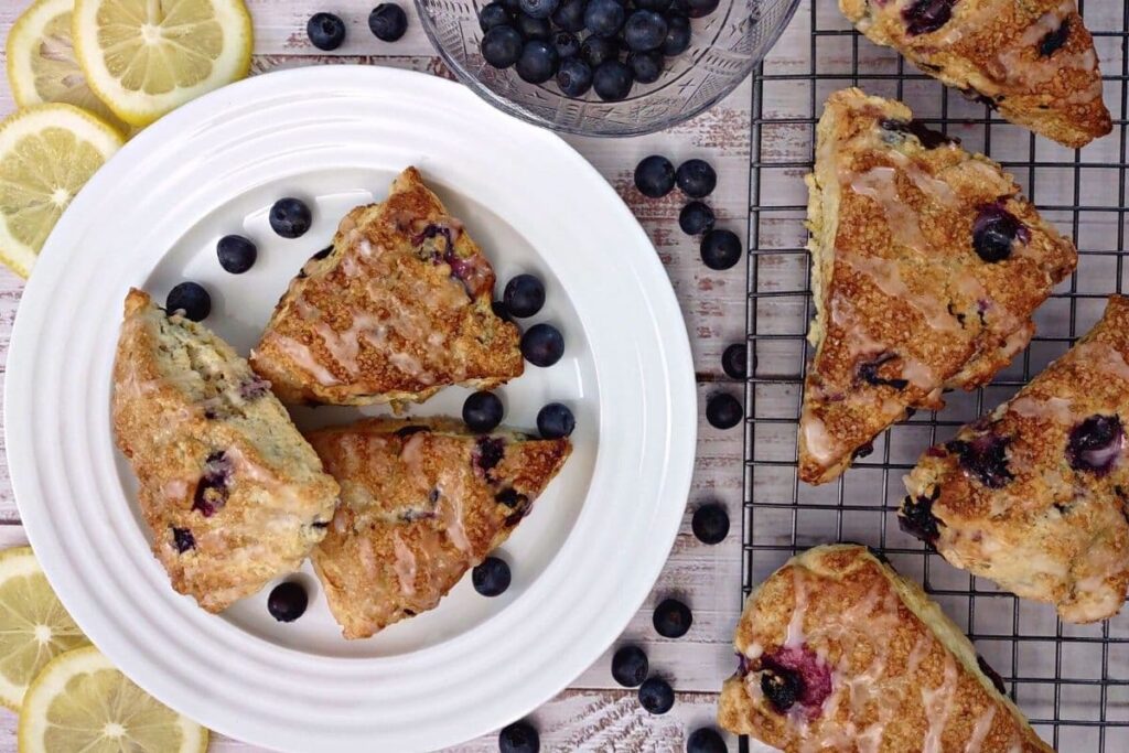 overhead view of air fryer blueberry scones on a plate with fresh fruit