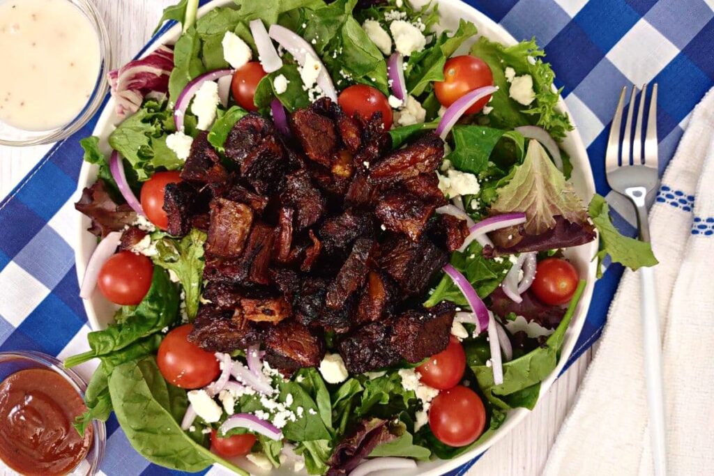 overhead view of brisket burnt ends on a salad