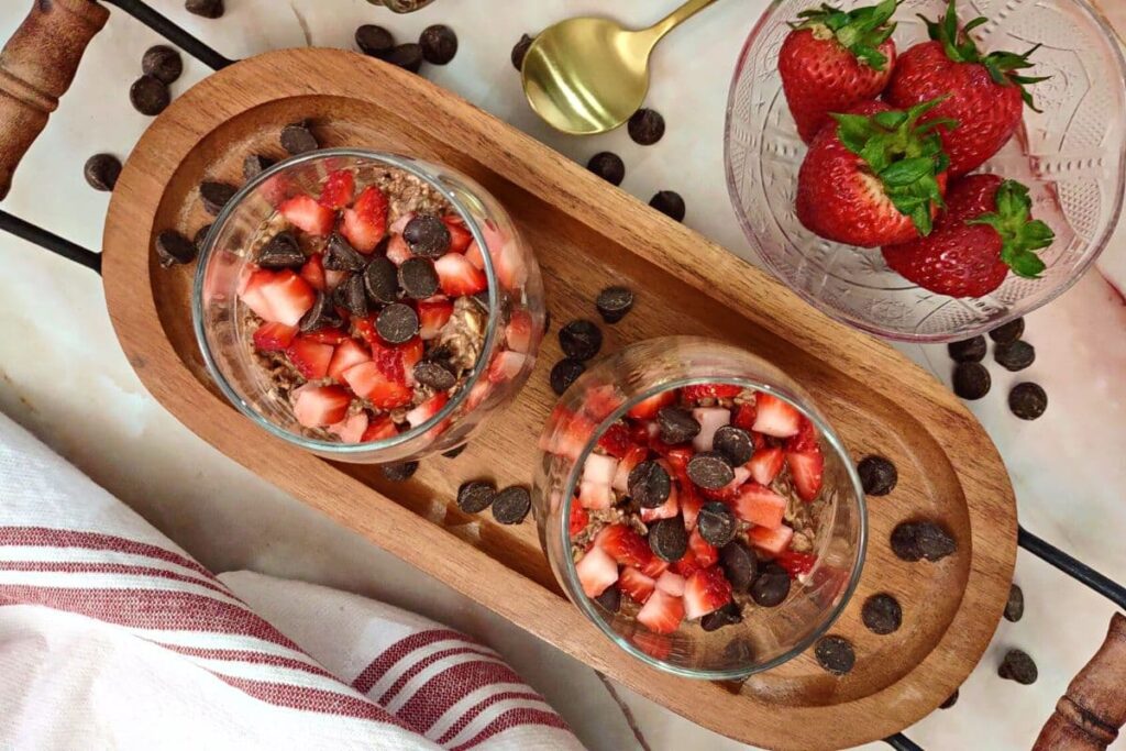 overhead view of two glasses of chocolate strawberry overnight oats