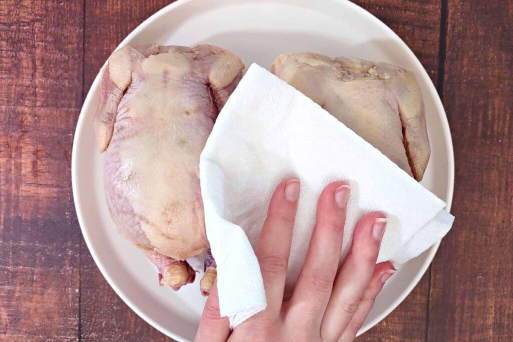 pat cornish hen dry with a paper towel