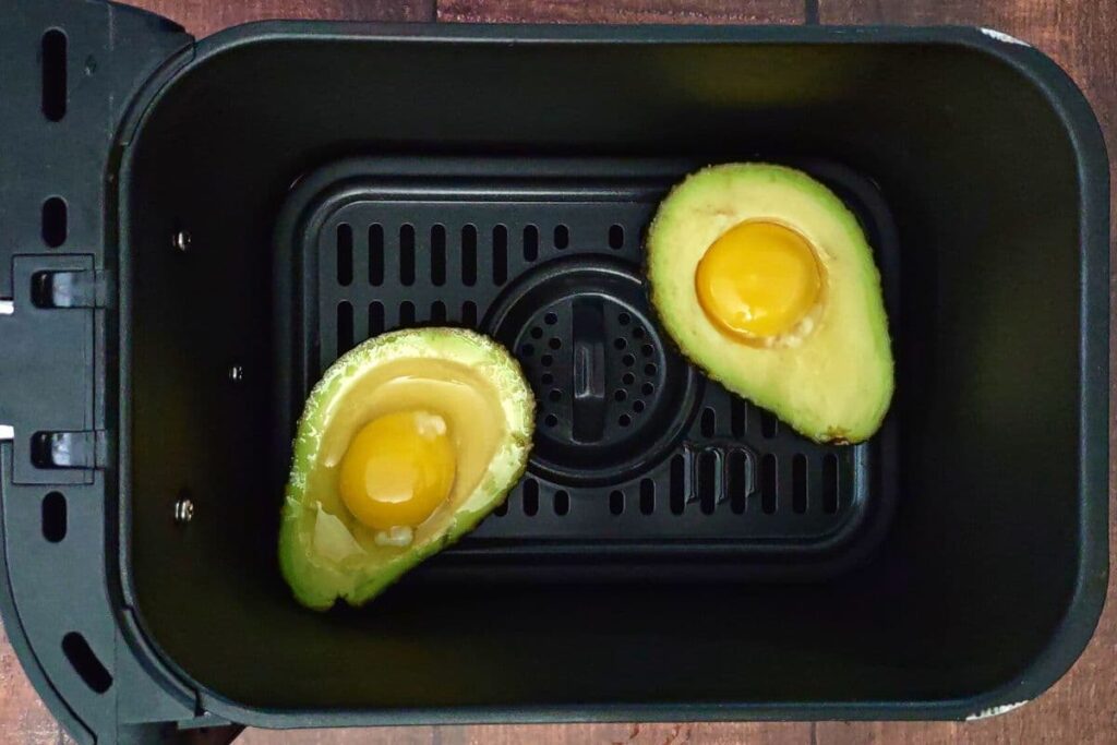 place avocado eggs in air fryer basket