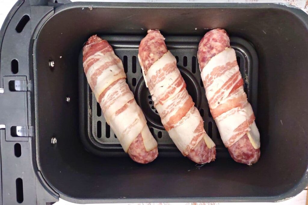 place bacon wrapped brats in air fryer basket