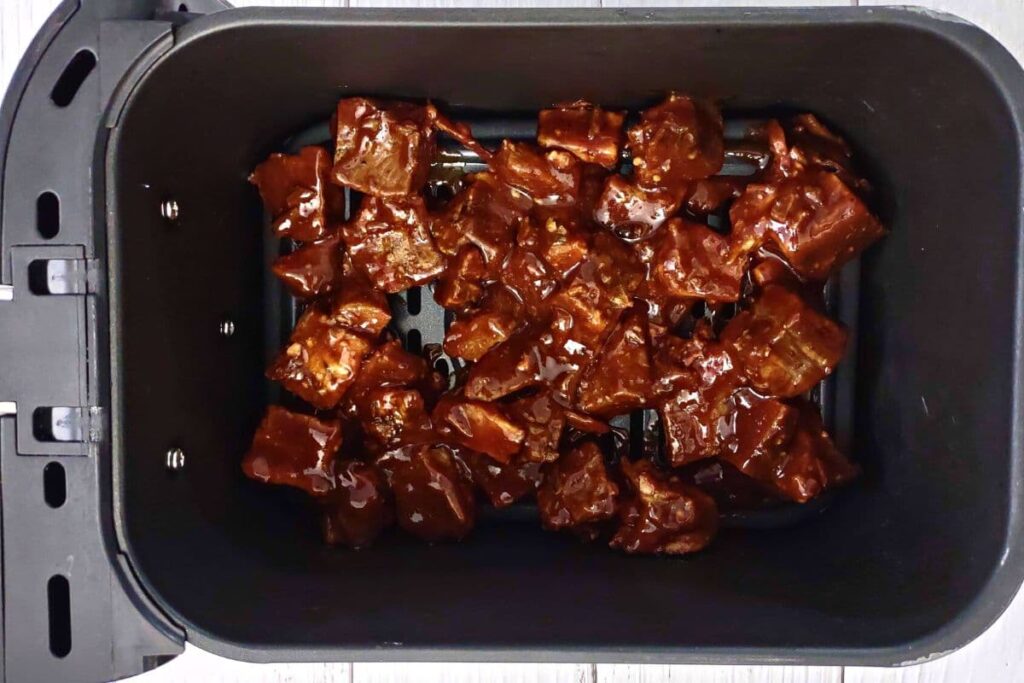 place sauced burnt ends in air fryer basket