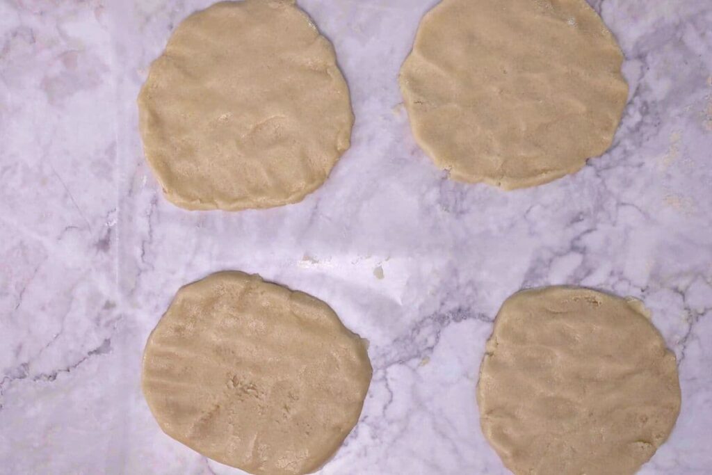 press cookie dough down into appropriate shape