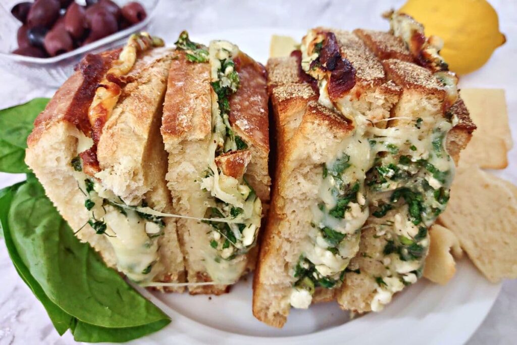spanakopita grilled cheese halves sitting side by side