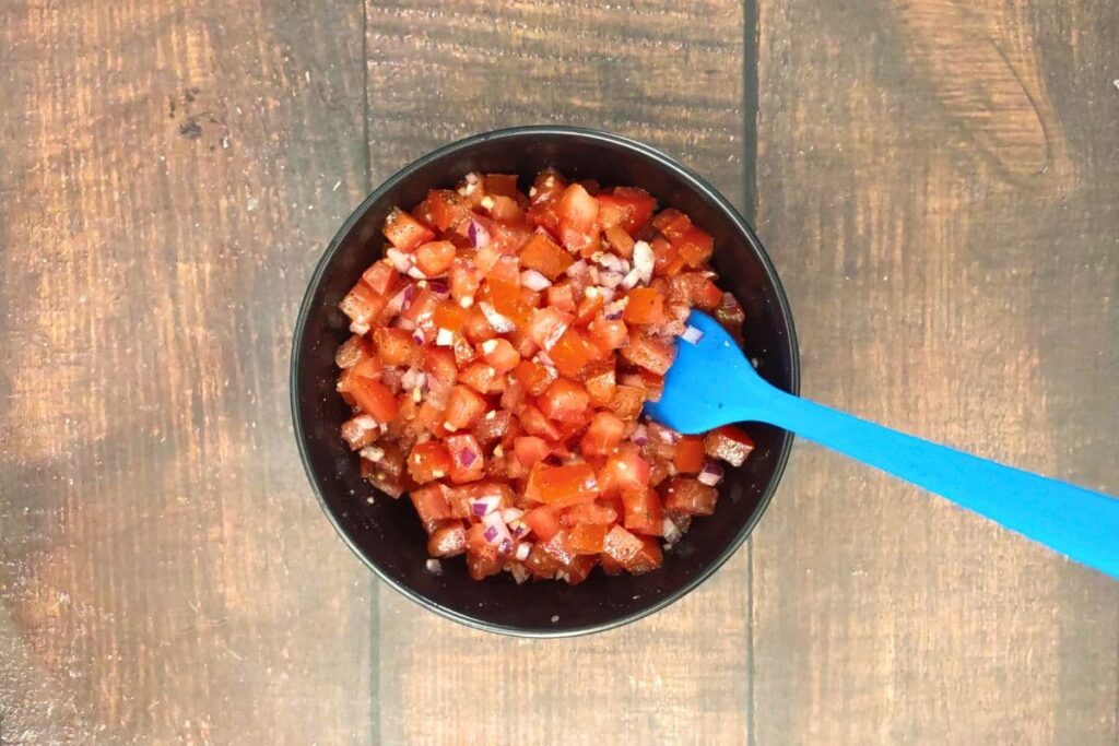 combine tomatoes, onion, garlic, olive oil, salt, and pepper in a small bowl