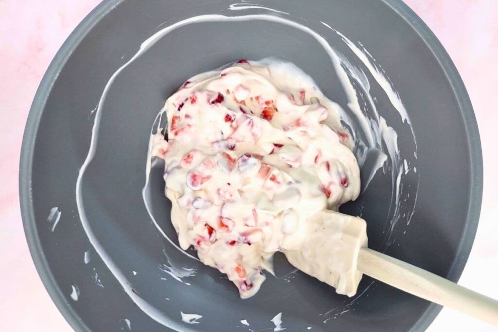 mix chopped strawberries and greek yogurt in a bowl