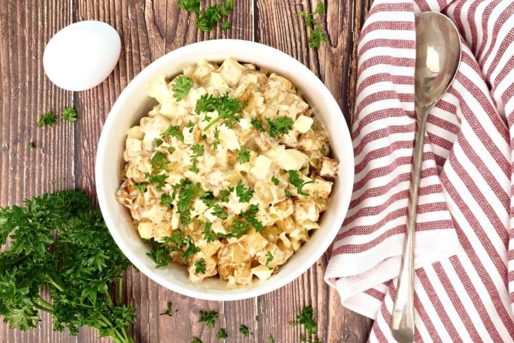 overhead view of air fryer potato salad in a bowl with fresh parsley