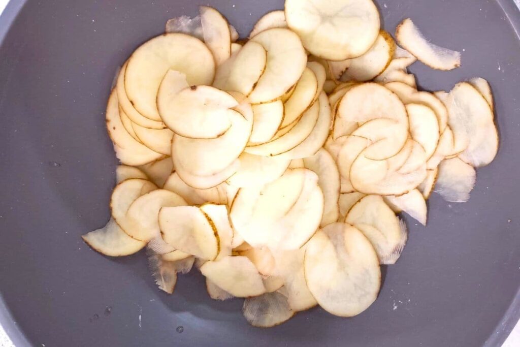 place fresh potato slices in a bowl