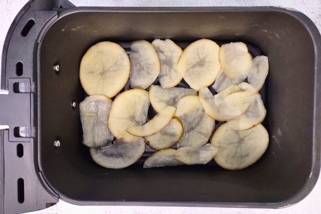 place sliced potatoes in air fryer basket
