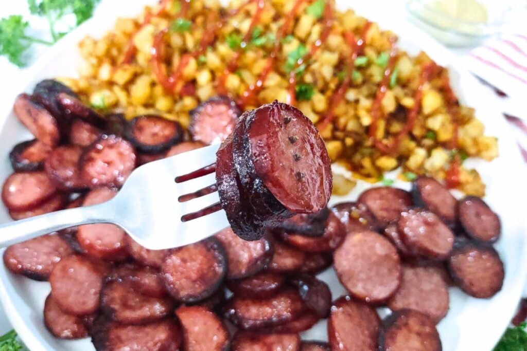 slices of air fried smoked sausage on a fork