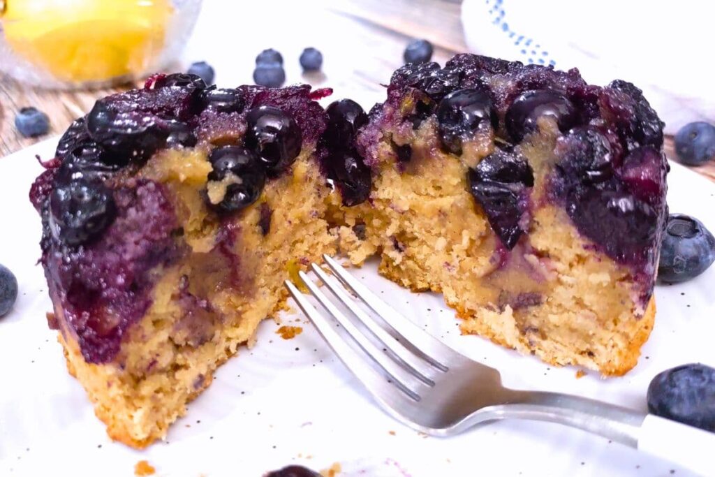 cutting in half air fryer blueberry cake with a fork