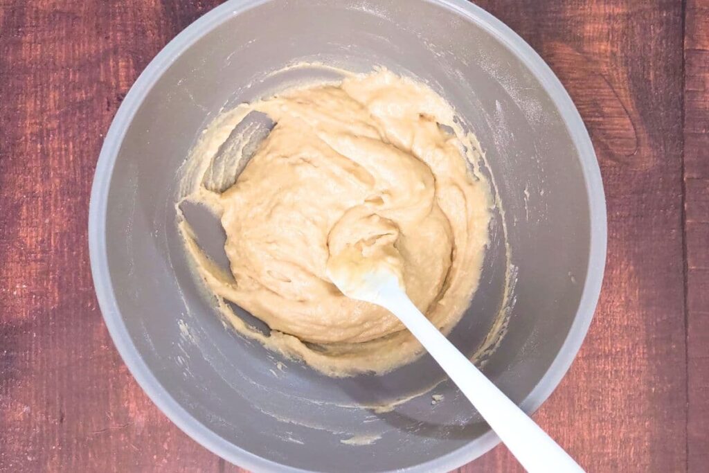 for berry cobbler batter mix butter, flour, brown sugar, baking powder, vanilla, and cream