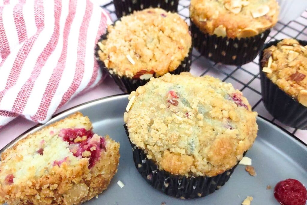 light and fluffy raspberry sour cream muffins on a plate