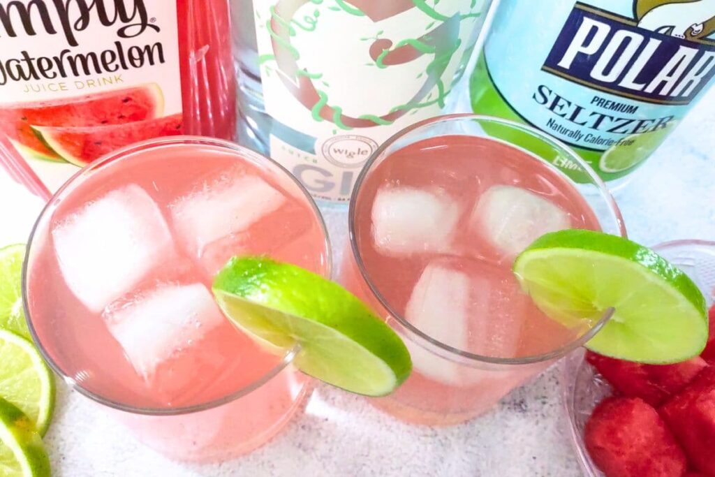 looking down at watermelon gin fizz drinks with lime slices