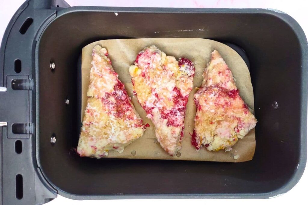 separate raspberry scones in the bottom of the air fryer basket