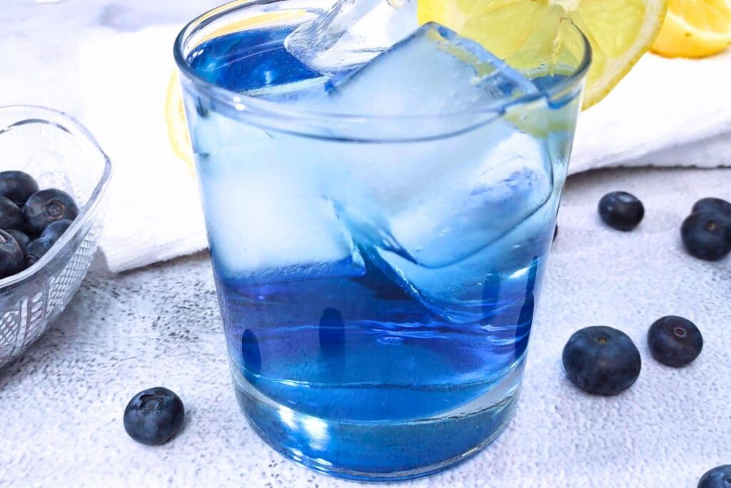 single closeup of blueberry gin cocktail in a rocks glass