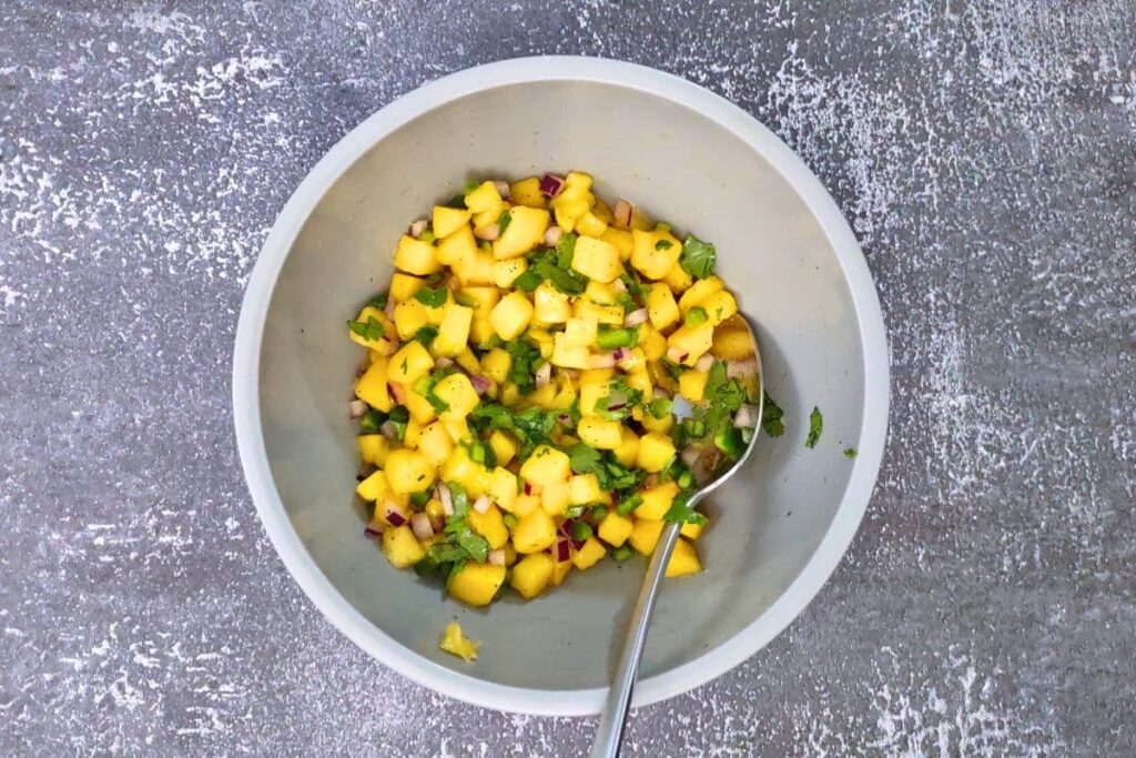 combine ingredients to make jalapeno mango salsa in a small bowl