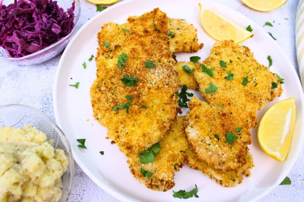 crispy air fryer chicken schnitzel with mashed potatoes and red cabbage