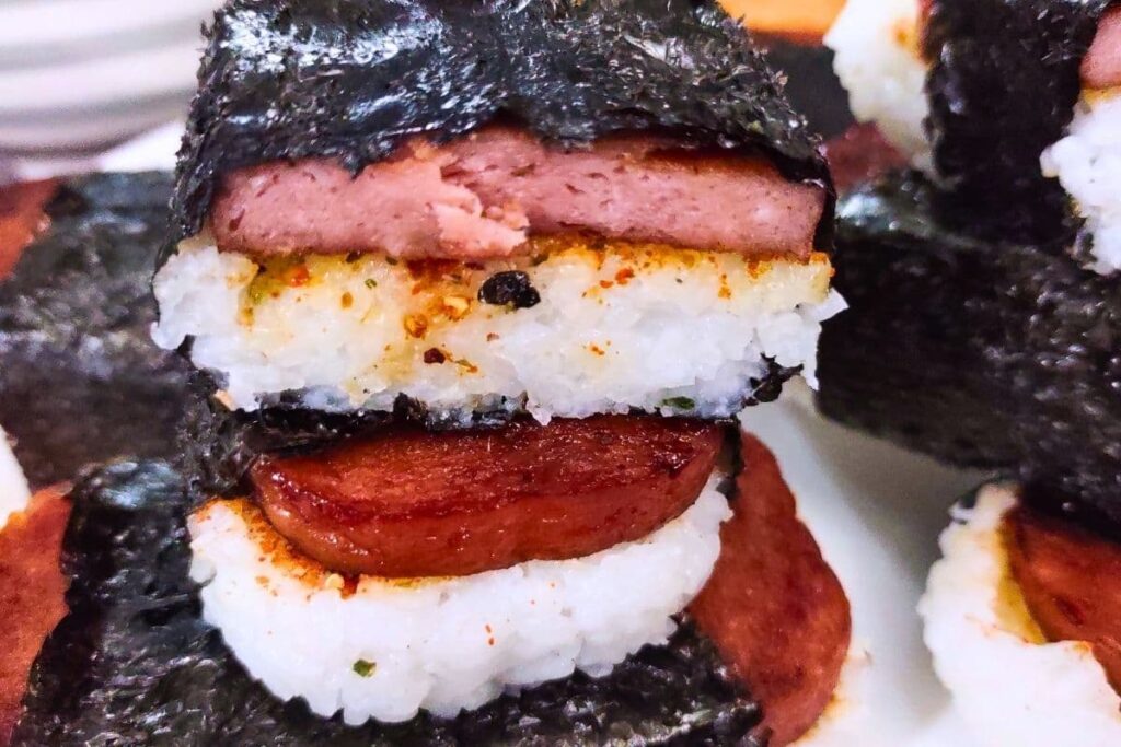 cut in half roll of spam musubi stacked on top of each other
