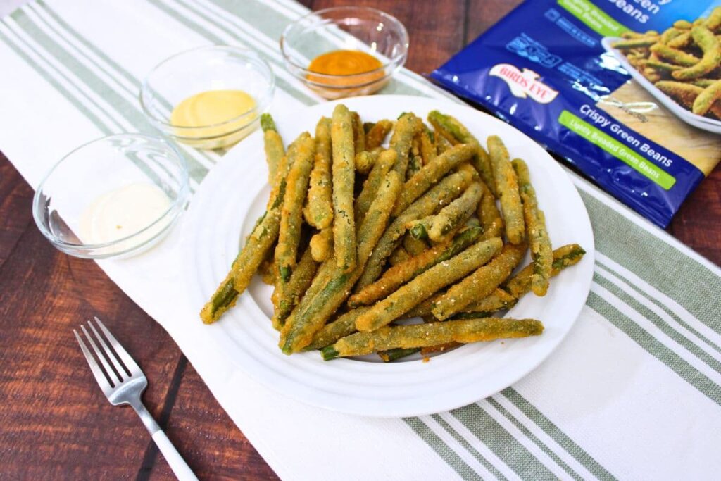easy crispy birds eye green beans on a plate with dipping sauce