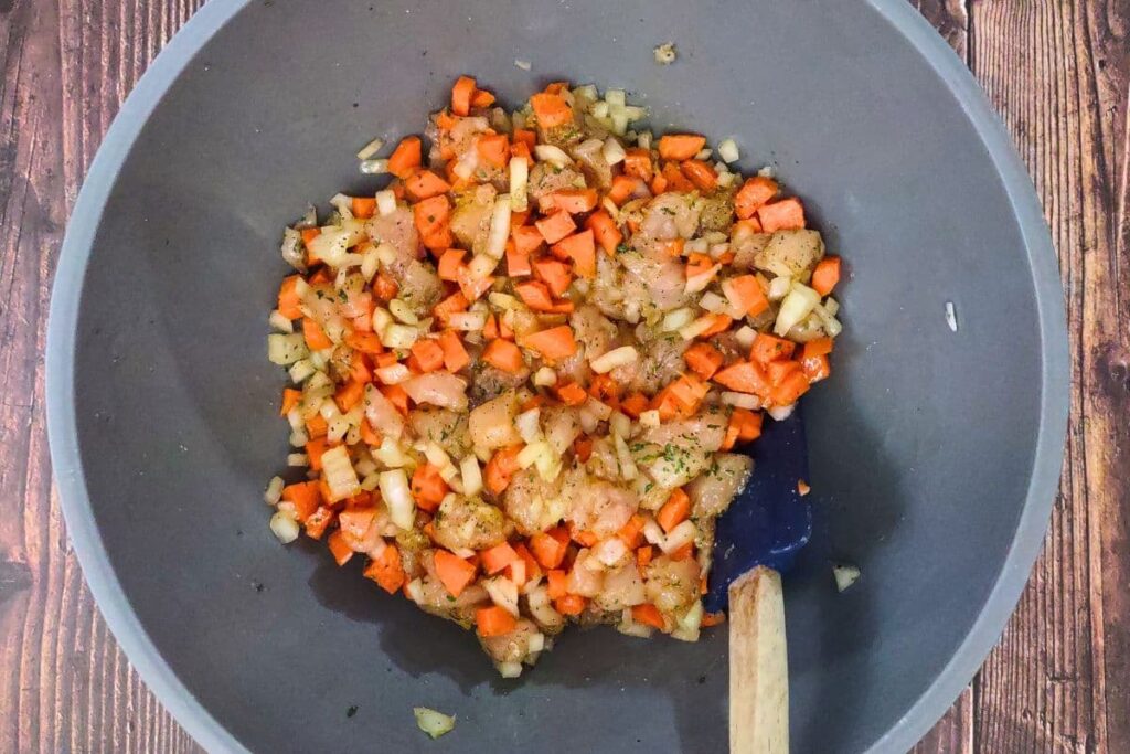 mix the cubed chicken breast with your vegetables and seasoning in a small bowl