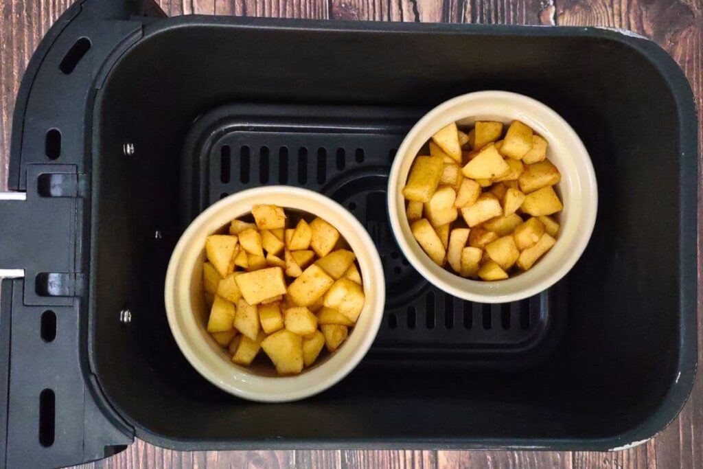 place apples in their oven safe dishes in the air fryer basket