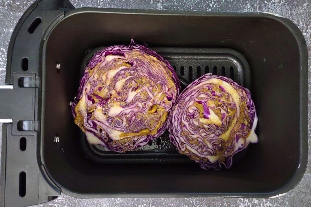 place red cabbage slices in air fryer basket and brush the tops with the sauce