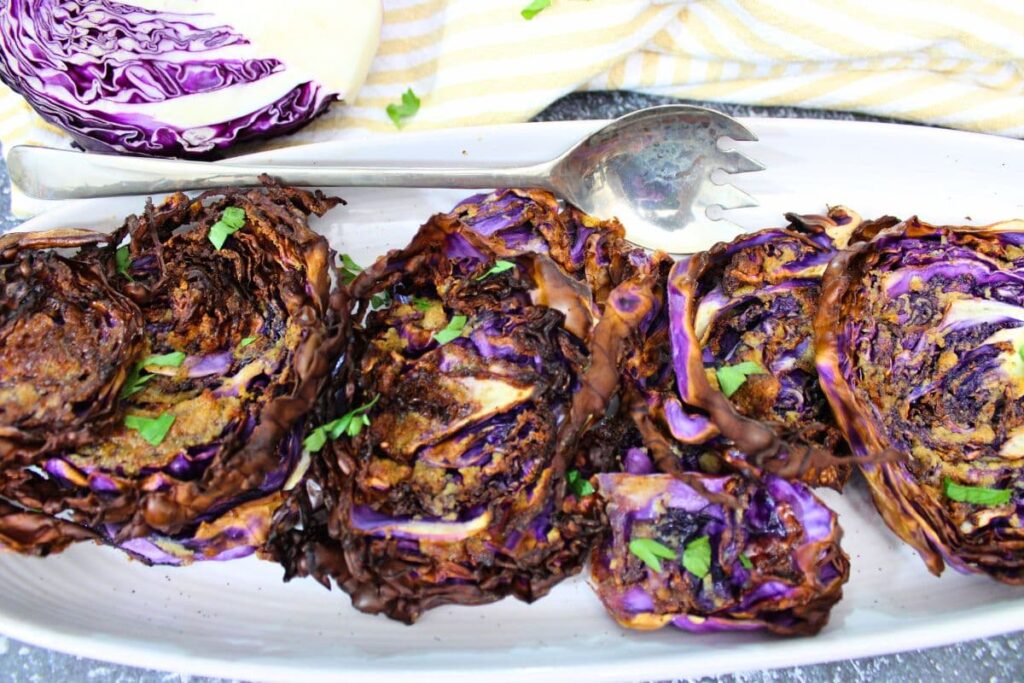 several slices of air fryer red cabbage on a serving platter