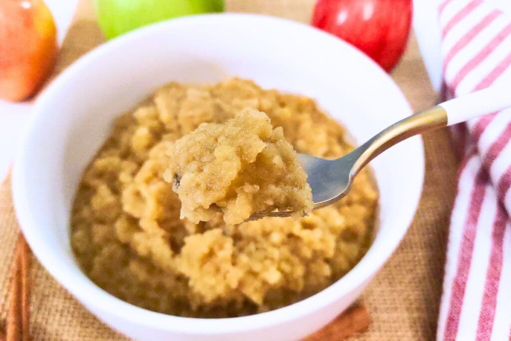 spoonful of homemade microwave applesauce with cinnamon and bourbon
