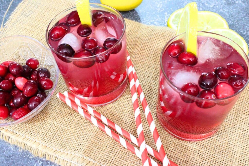 two glasses of vodka cranberry lemonade with fresh lemon and cranberries